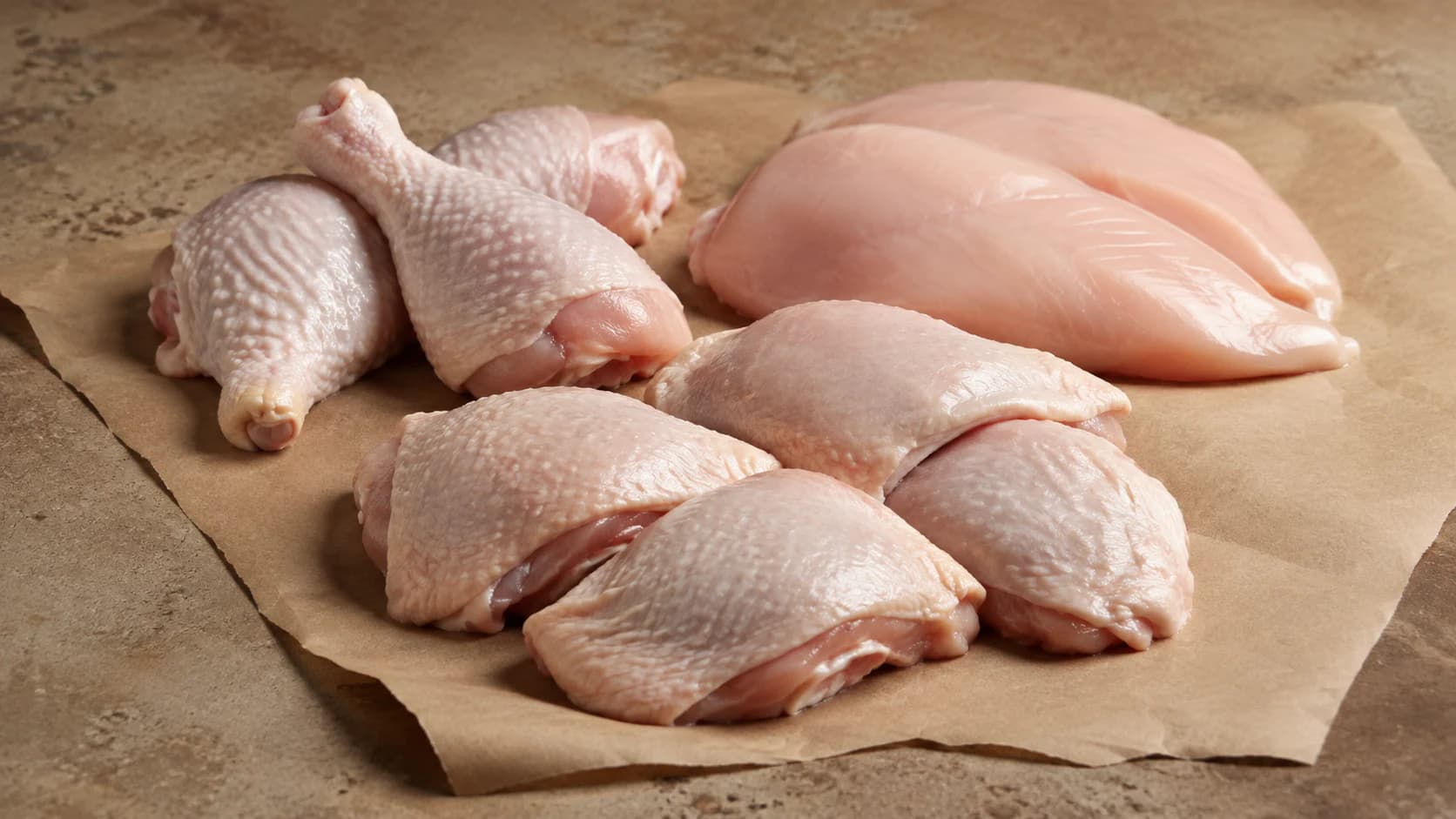 Poultry cuts arranged on natural butcher paper